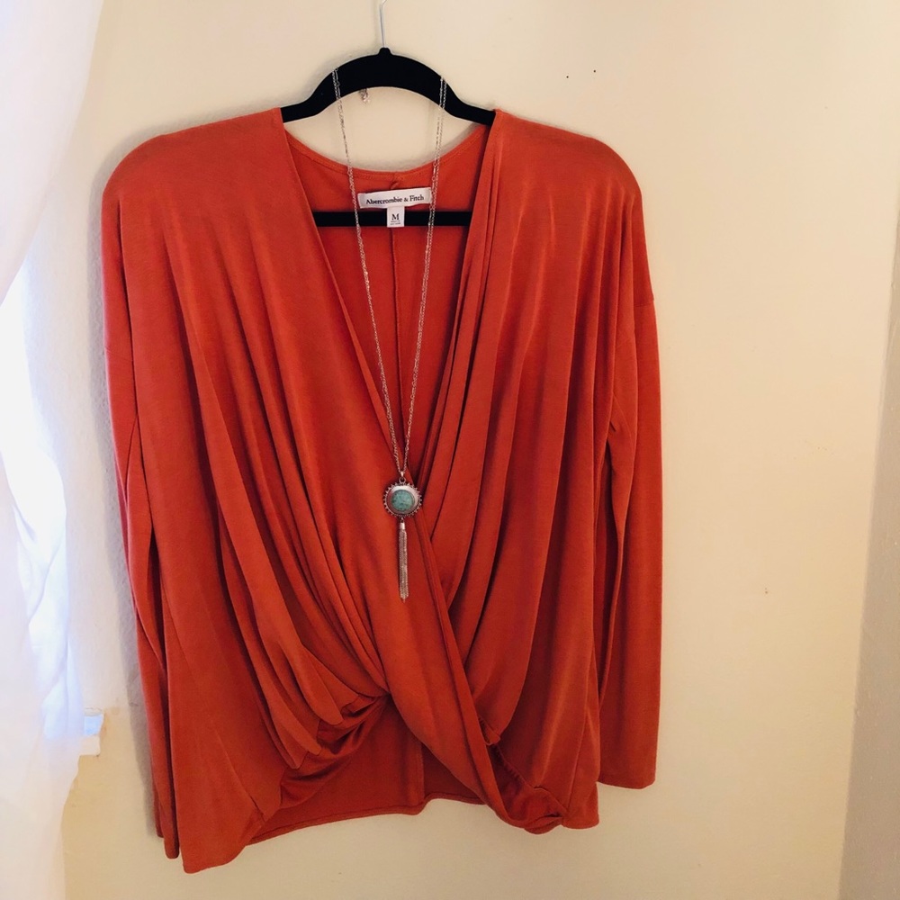Rustic orange , low-cut long sleeve top.
